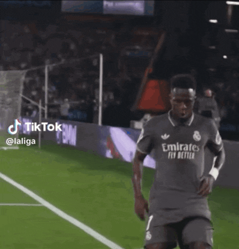 a soccer player wearing a shirt that says emirate fly better