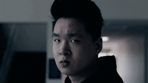 a close up of a man 's face with a hoodie on