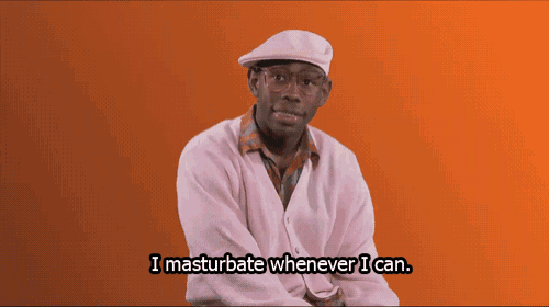 a man wearing glasses and a pink shirt says i masturbate whenever i can