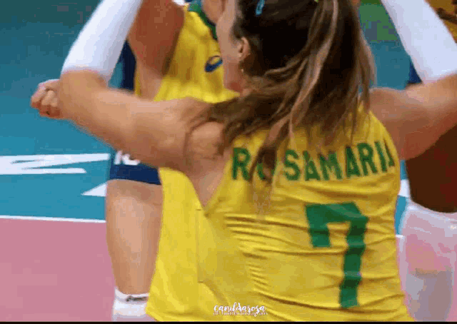 a woman wearing a yellow jersey with the name rosamaria on it