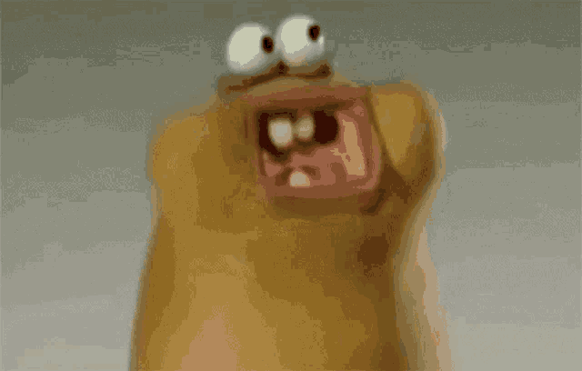 a close up of a cartoon character with a big mouth and eyes .