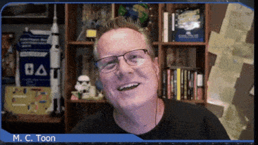 a man wearing glasses and headphones is smiling in front of a bookshelf with the name m.c. toon on the bottom