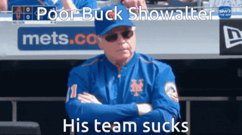 a man in a blue mets jacket with his arms crossed