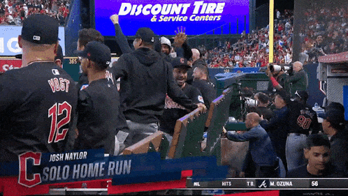 a baseball game is being played in front of a discount tire banner