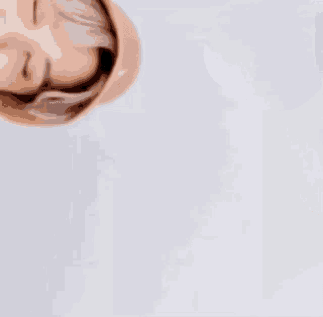 a close up of a person 's face with their eyes closed .