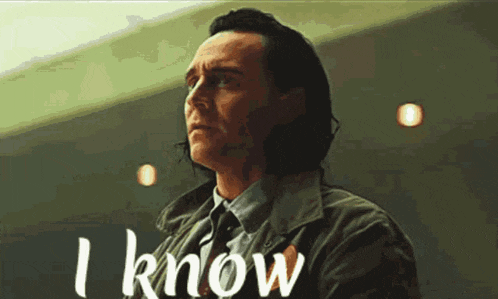 a man in a suit and tie says i know in white letters