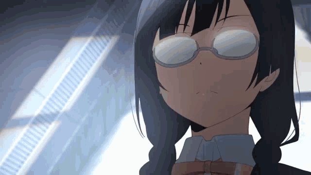 a girl wearing glasses looks at the camera