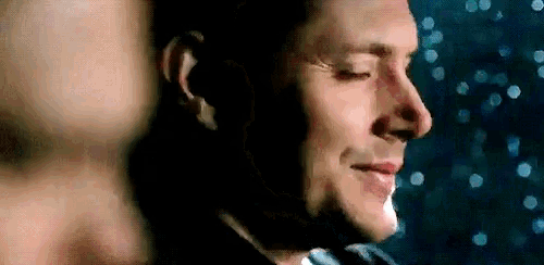 a close up of a man 's face in the dark with his eyes closed .
