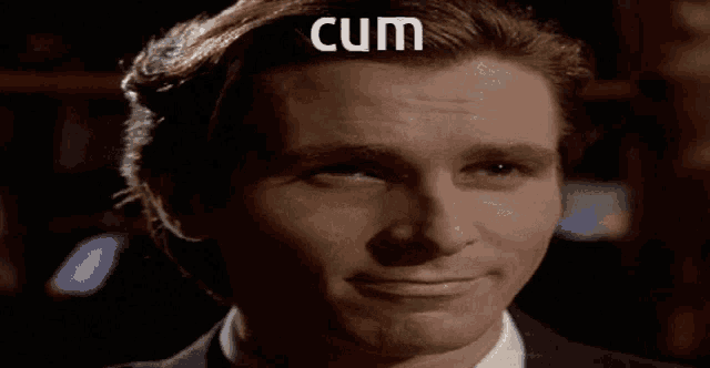 a close up of a man 's face with the word cum above his head