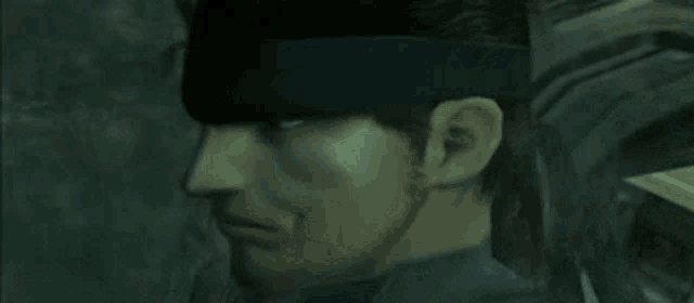 a close up of a man 's face wearing a headband