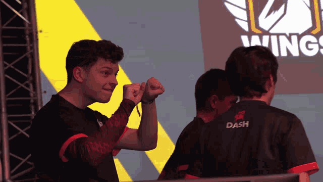 a man wearing a black shirt that says dash on the back