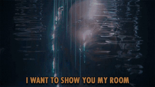 a man with glasses and the words i want to show you my room behind him