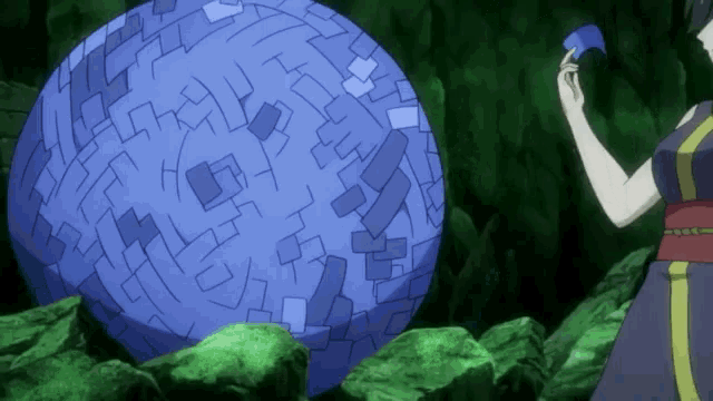 a woman is standing in front of a large blue ball with a face on it