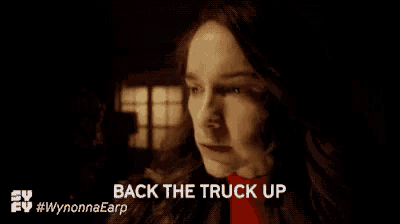 a close up of a woman 's face with the words `` back the truck up '' written below her .