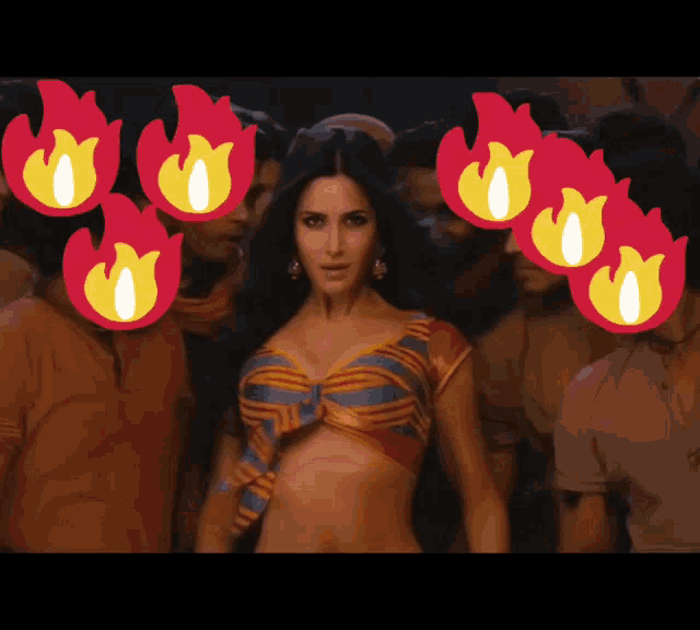 a woman in a striped top is surrounded by a crowd of people with flames on their faces