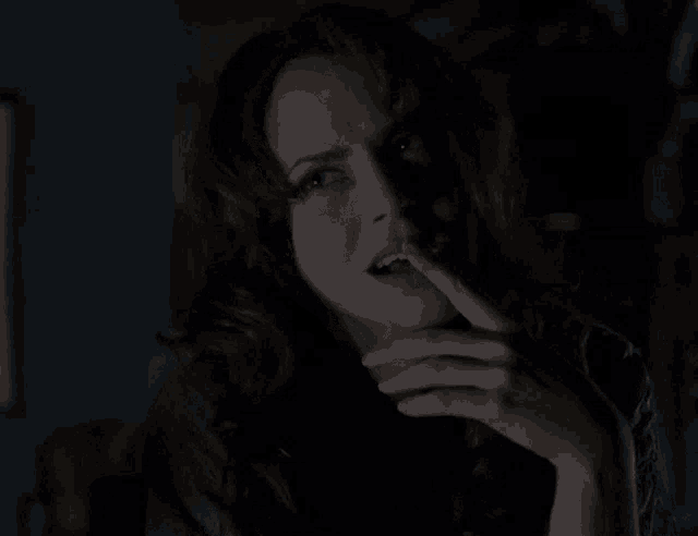 a woman with her eyes closed and her mouth open