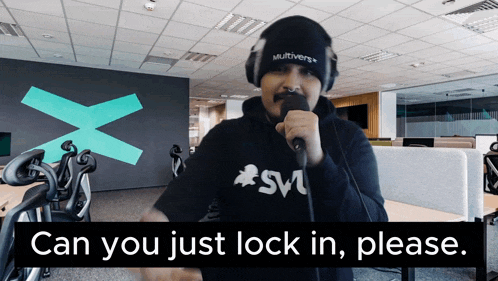 a man singing into a microphone with the words can you just lock in please on the bottom