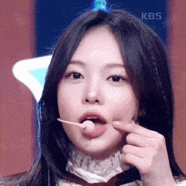a close up of a woman 's face with a kbs logo in the corner