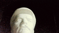 a statue of a man with a beard is sitting on a table