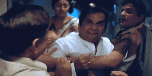 a group of men are having a fight and one of them is wearing a ring