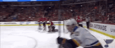 a hockey game is being played in front of a gatorade banner