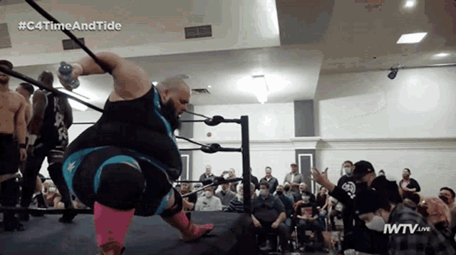a man in a wrestling ring with the hashtag # c4timeandtide