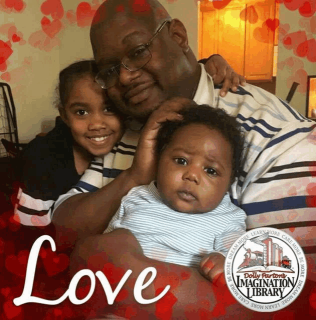 a picture of a man holding a baby with the word love written on it