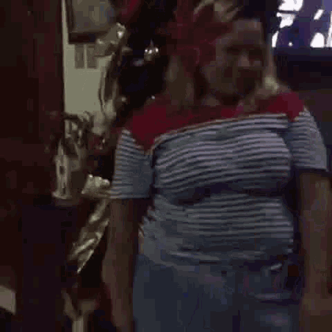 a person is standing in front of a christmas tree wearing a shirt with lights on it