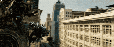 a transformer is flying over a city with a building in the background