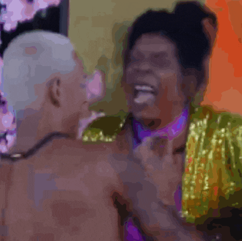 a blurry picture of a man and a woman laughing together