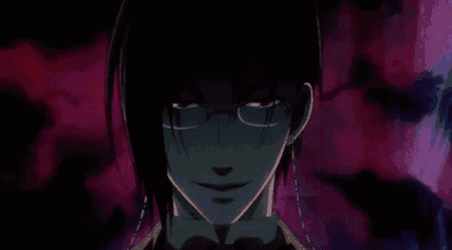 a close up of a man wearing glasses and a bow tie in a dark room .