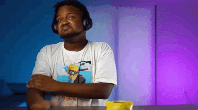 a man wearing headphones and a t-shirt with naruto on it