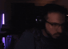 a man wearing glasses and headphones is looking at the camera