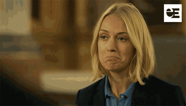 a woman making a face with a e7 logo in the corner