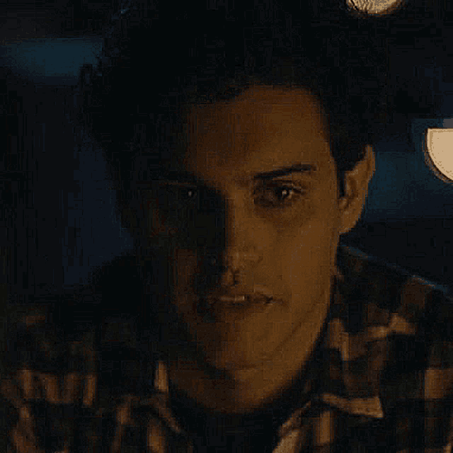 a close up of a man 's face in a dark room