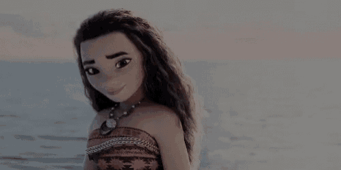 a doll is standing on the beach near the ocean .