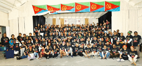 a large group of people are posing for a picture and one of their shirts says " ethiopia "