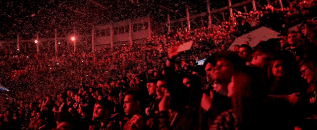 a crowd of people sitting in a stadium with a sign that says ' a & e ' on it