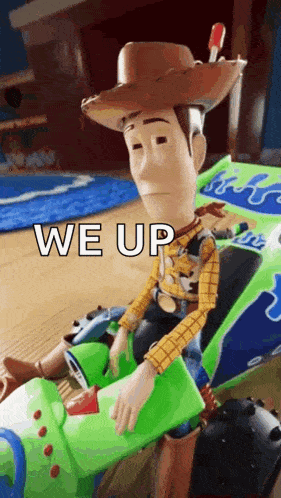 woody from toy story is sitting in a toy car with the words `` we up '' written on it .