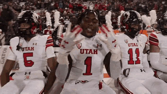 a group of utah football players kneeling down