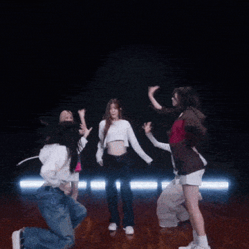 a group of girls are dancing together on a stage