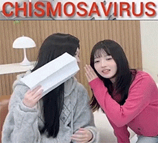 two girls are sitting next to each other on a couch .