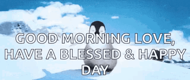 a penguin is standing in the snow with a good morning love , have a blessed and happy day message .