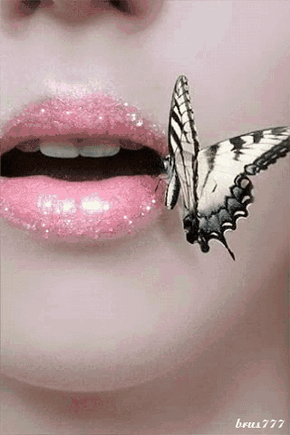 a butterfly is perched on a woman 's pink lips