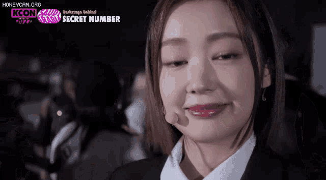 a close up of a woman 's face with the words secret number on the bottom right