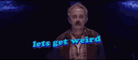 a man with glasses and a mustache is standing in front of a sign that says lets get weird
