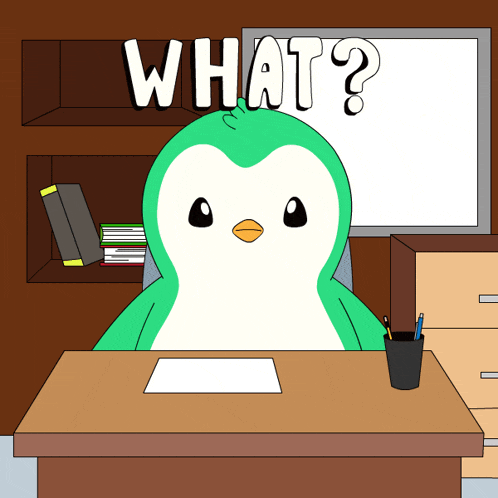a penguin sits at a desk in front of a white board that says " what "