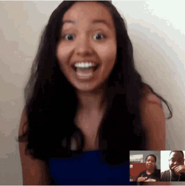 a woman is smiling while talking to a man