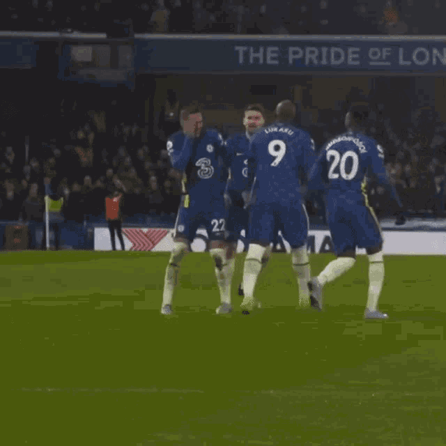 soccer players on a field in front of a banner that says " the pride of london "