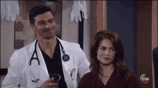 a doctor and a nurse are standing next to each other .